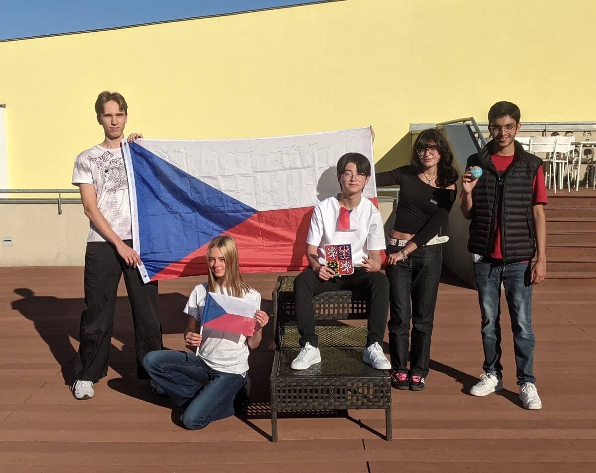 Team Czechia 2023 with a large Czech flag on a rooftop